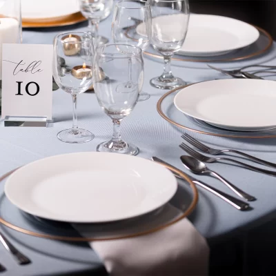 Wedding Decor Rental - Light Blue table Polyester Linen with clear charger with gold rim with an ivory napkin